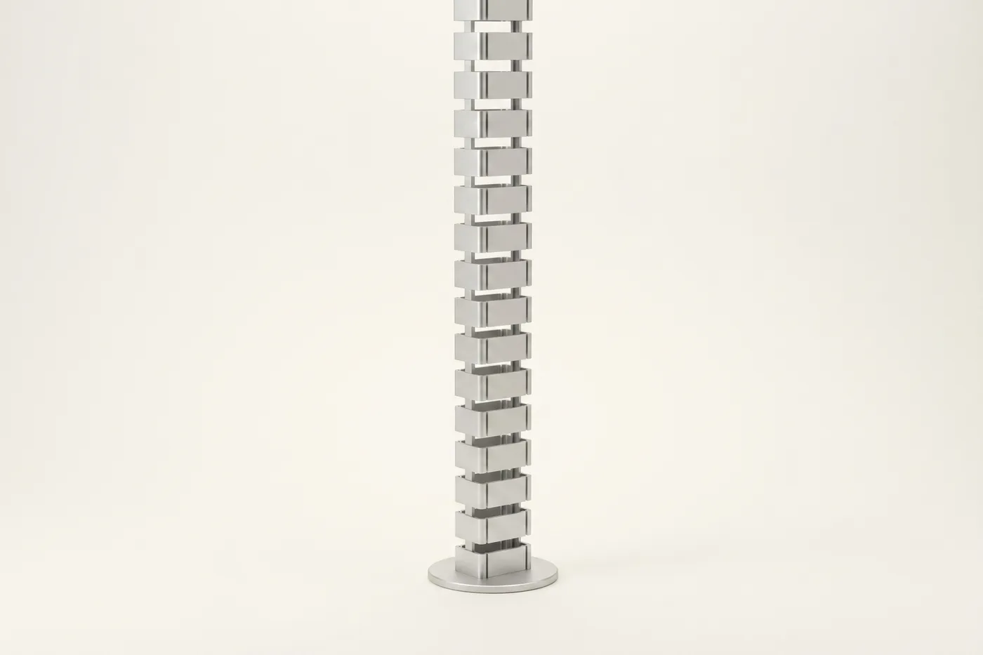 Vertical satin-silver aluminum cable spine with round base plate